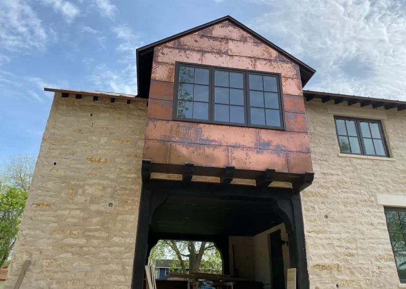 Copper metal panel facade on a stone building for Roof Repair in Madera Ranchos